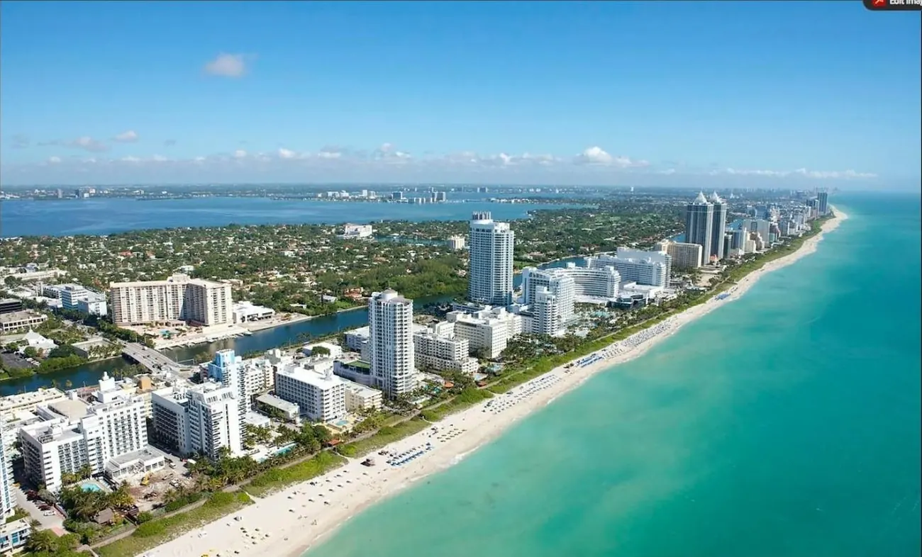 Aerial view of oceanfront condo towers and Biscayne Bay in Miami